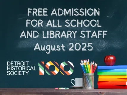 Chalkboard with free admission offer for school and library staff, August 2025. Desk with colorful pencils and apple. Detroit Historical Society logo.