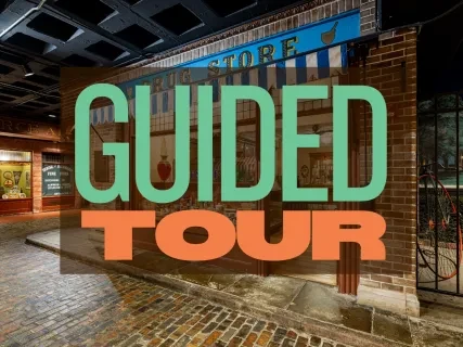 Brick path in a historic indoor setting with large "Guided Tour" text overlay.