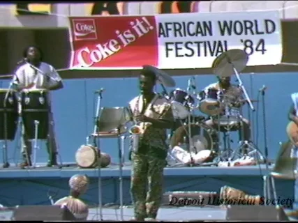 U-Matic - Day: Friday
Date: 8/24/84
Time: 12:30-2:30 P.M.
Subject: African World Festival / 8-24 thru 8-26 (noon 10:00 P.M.)
TV Shots: Band, Pan Shot of Crowd, 2-booths, Assorted Concessions, Artist, Jewelry, etc.