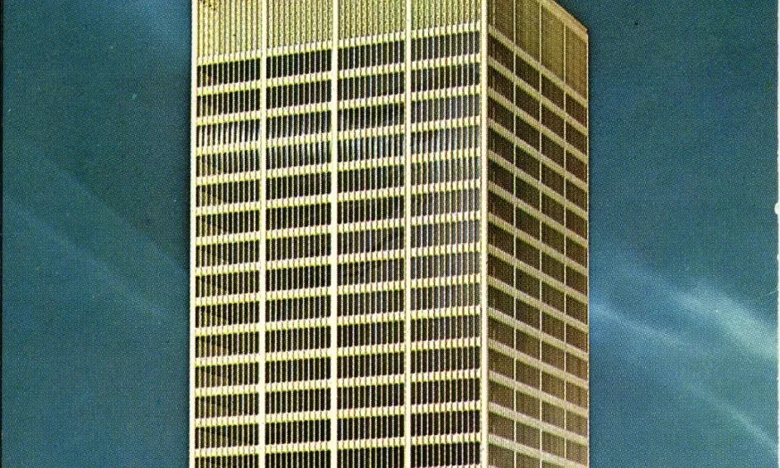 Tall skyscraper against a clear blue sky.