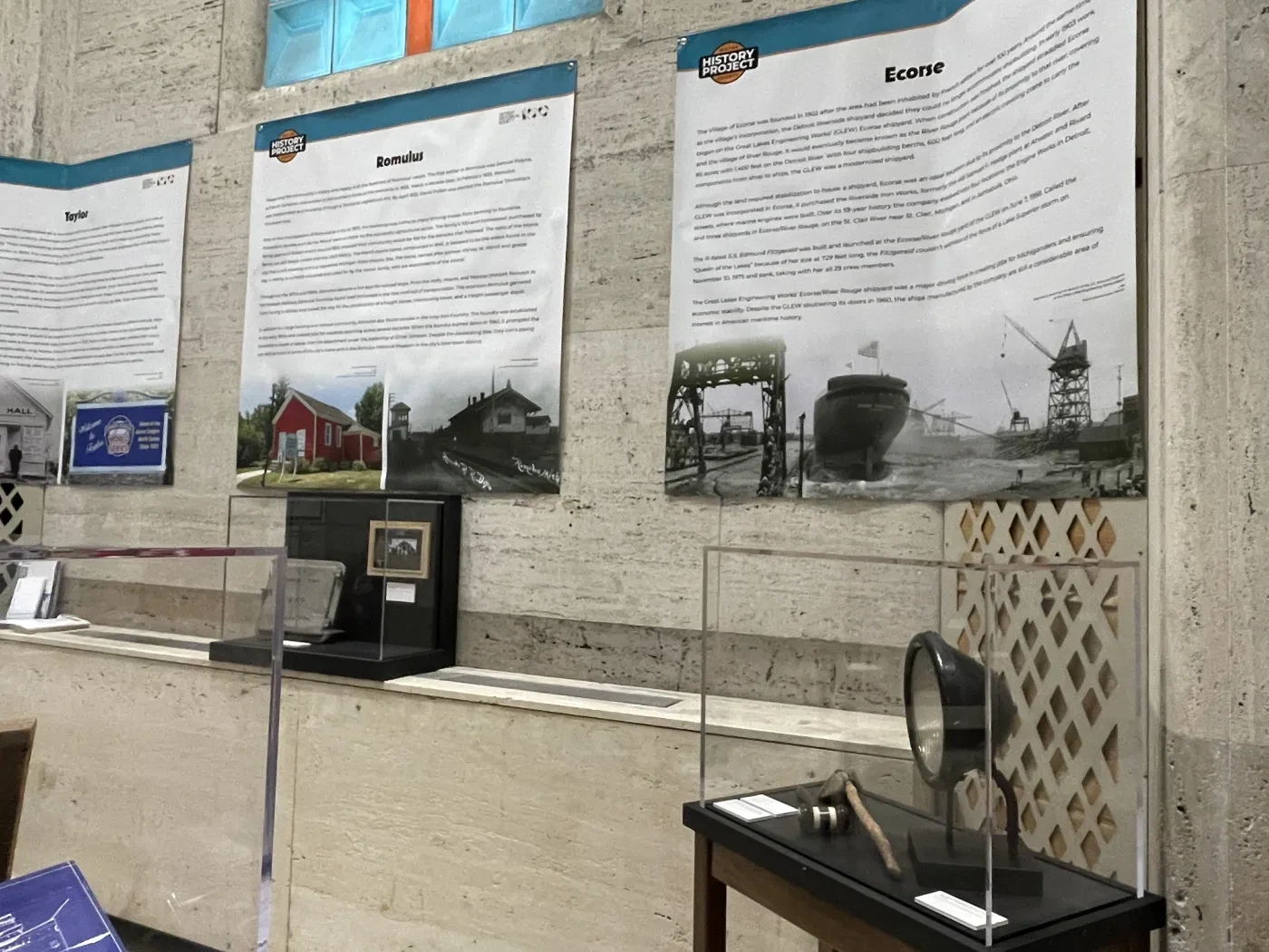Exhibit display with historical panels and vintage electronics on tables.