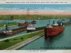 Postcard - Freighters Waiting Their Turn to Enter the Locks, Sault Ste. Marie, Mich. "In The Land of Hiawatha".
